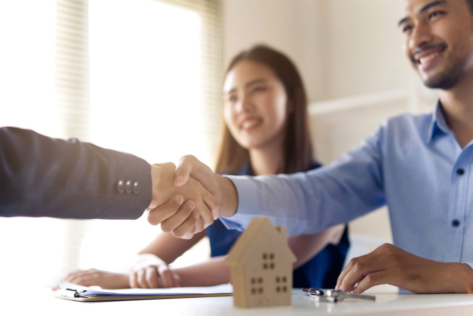 young-asian-couple-making-contract-with-house-sale